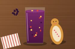 Vaso de colada morada ecuatoriana con frutas y una guagua de pan
