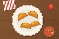 Empanadas de morocho doradas en un plato con ají de tomate de árbol